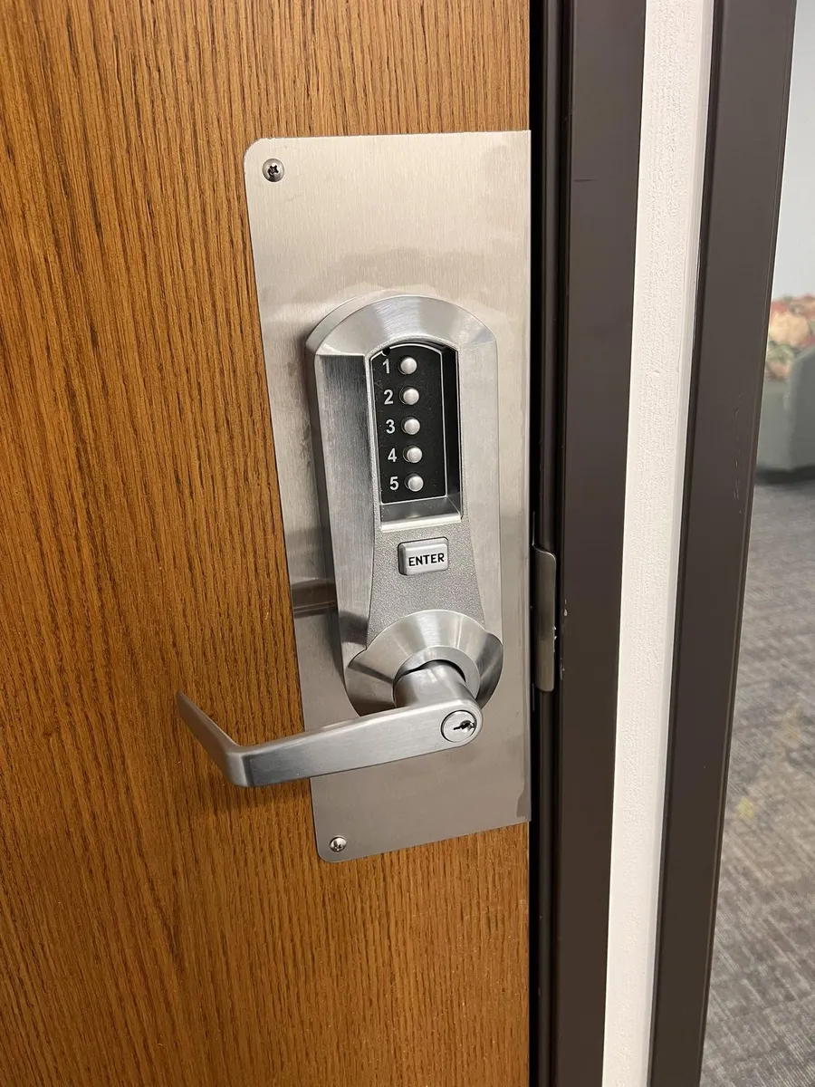 Mechanical pushbutton lever lock on a wood door