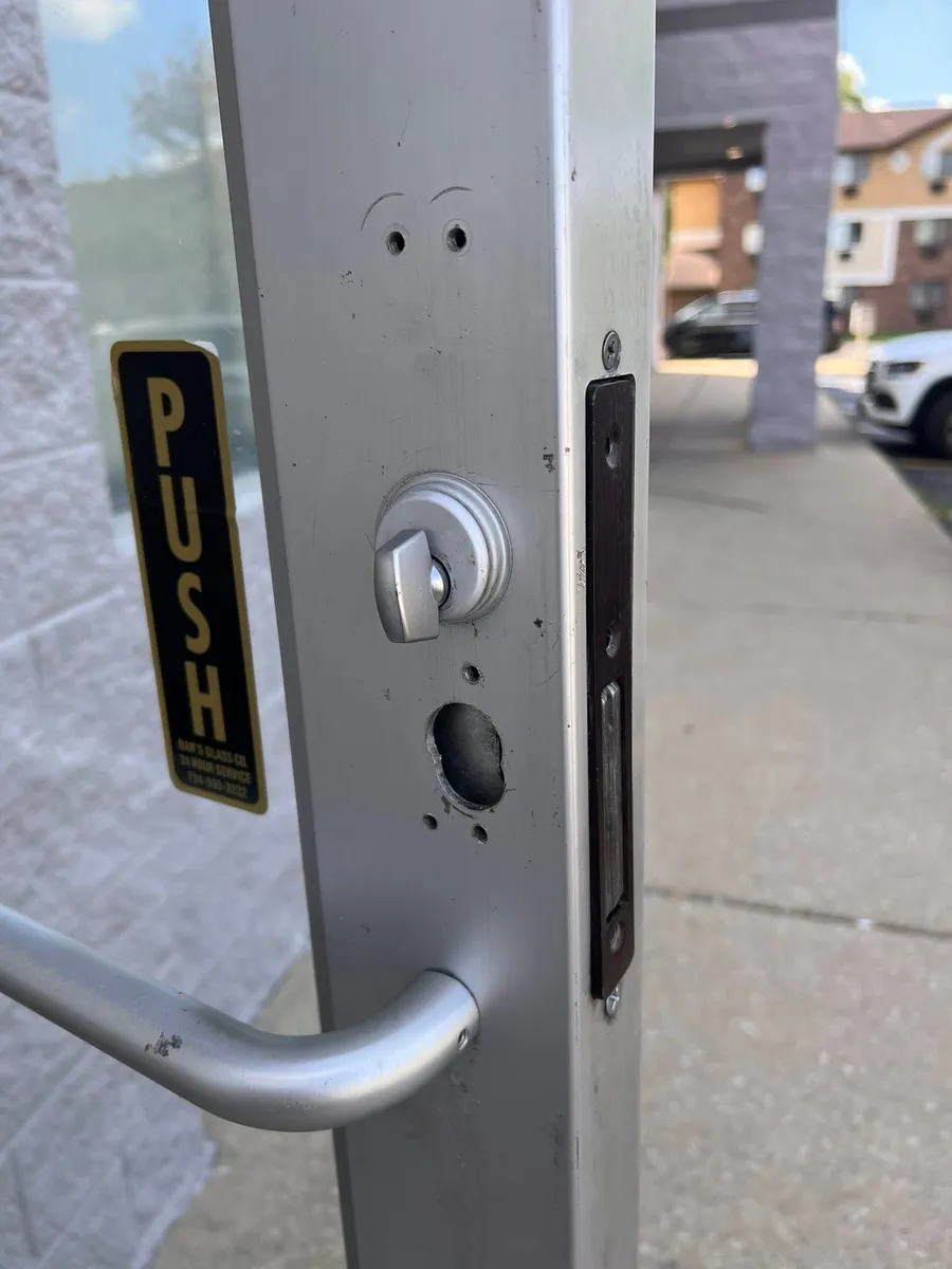 Lock cylinder and lever on a storefront door