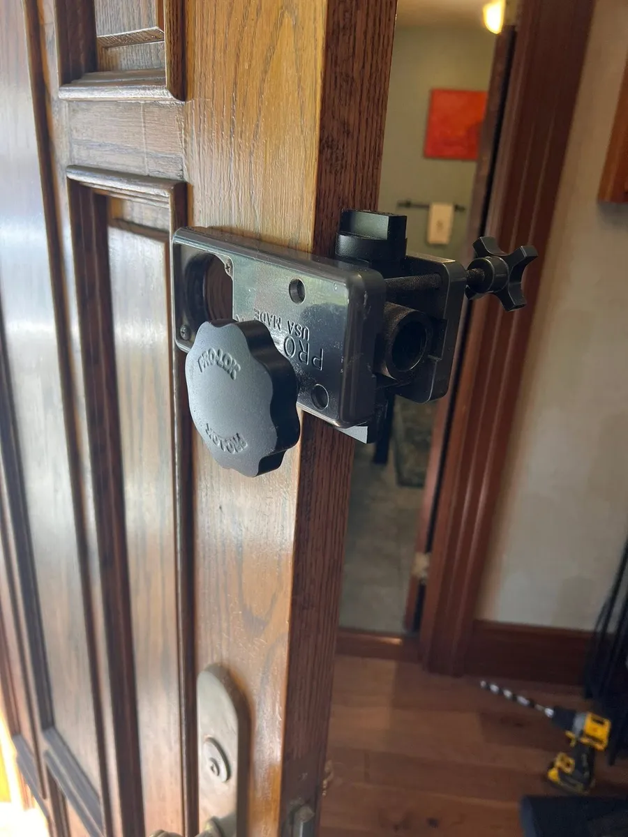 Drilling jig on a wood door for a deadbolt