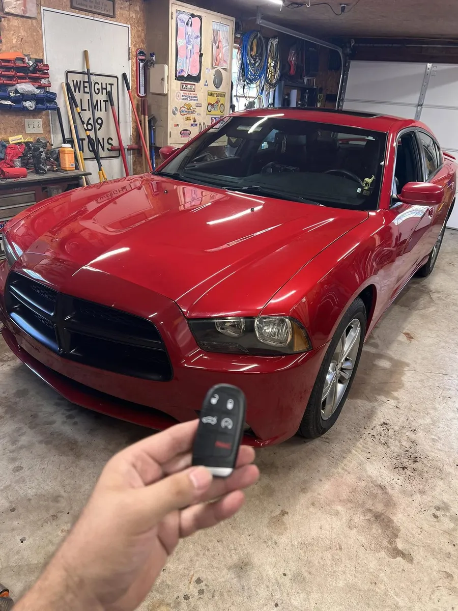 Smart key for a red Dodge Charger in a garage