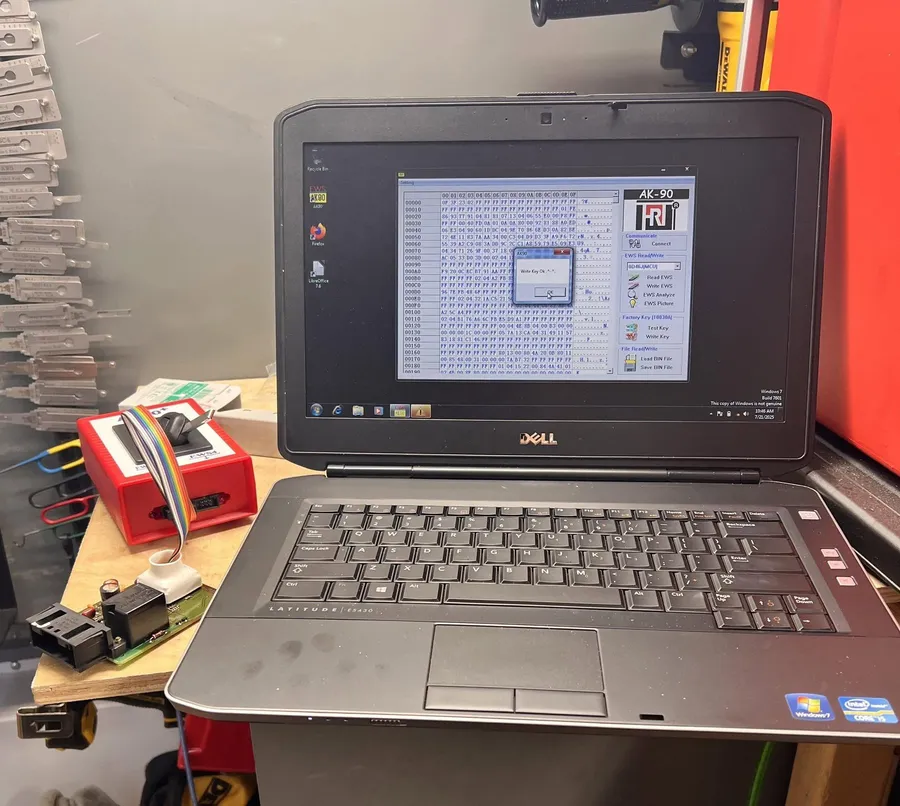 Laptop running key programming software on a workbench