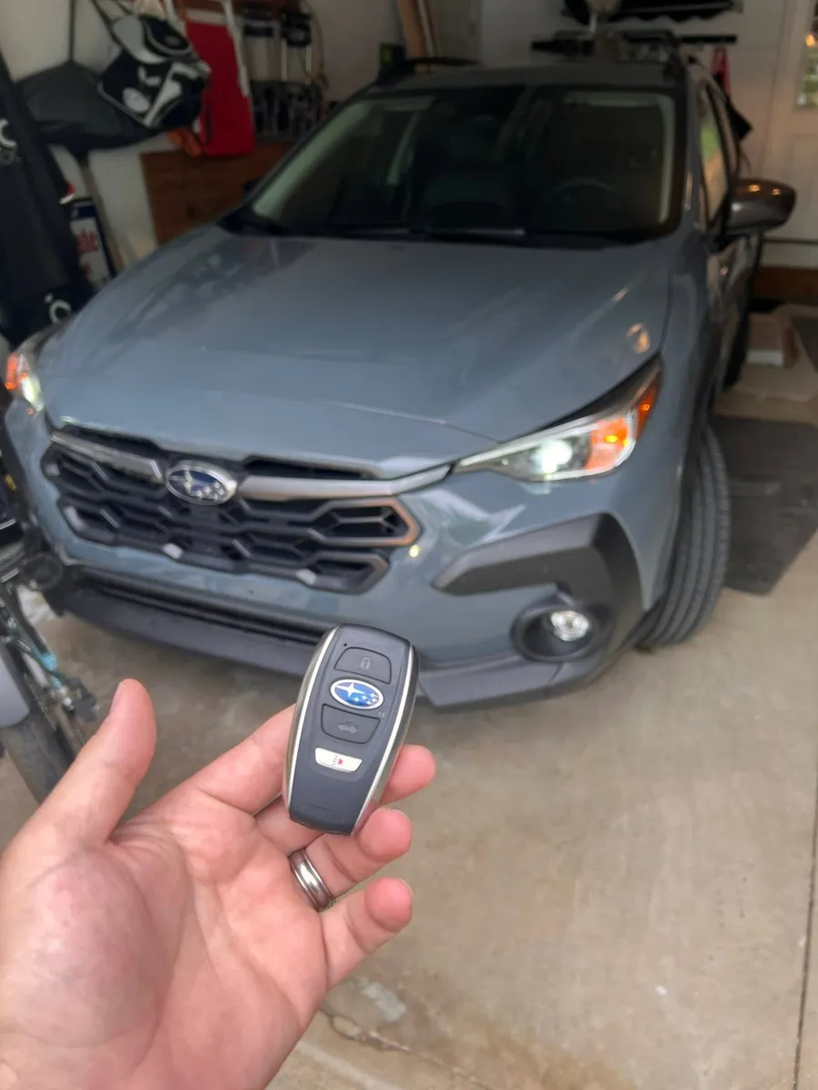 Smart key for a blue Subaru Crosstrek in a garage