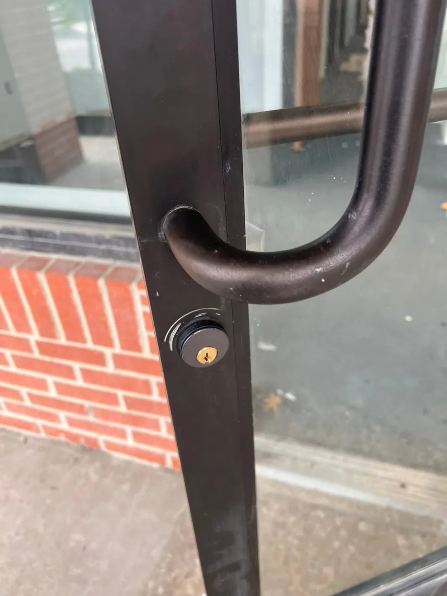 Pull handle and lock on a storefront door
