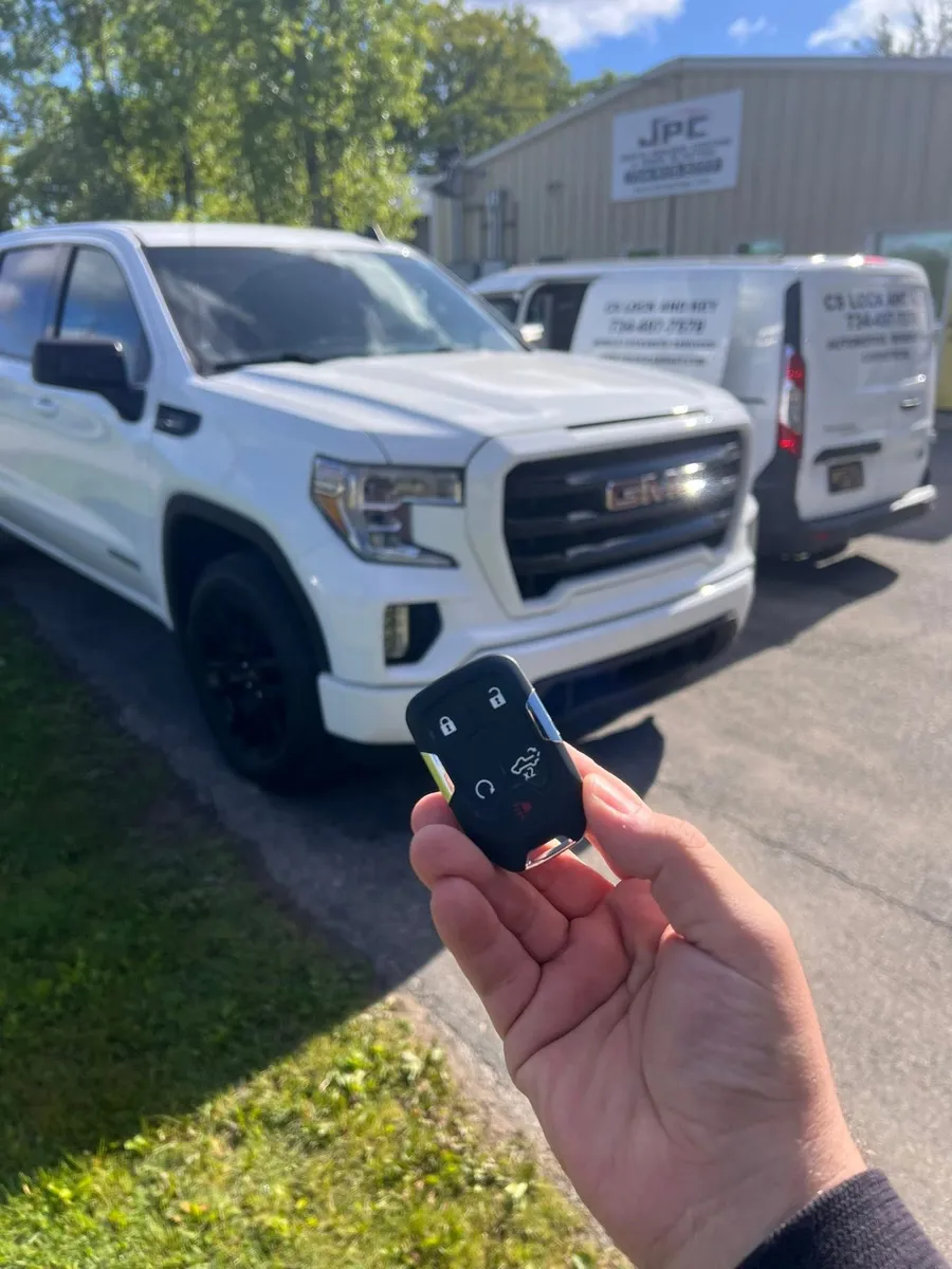 Smart key for a white GMC Sierra, with the CS Lock and Key van