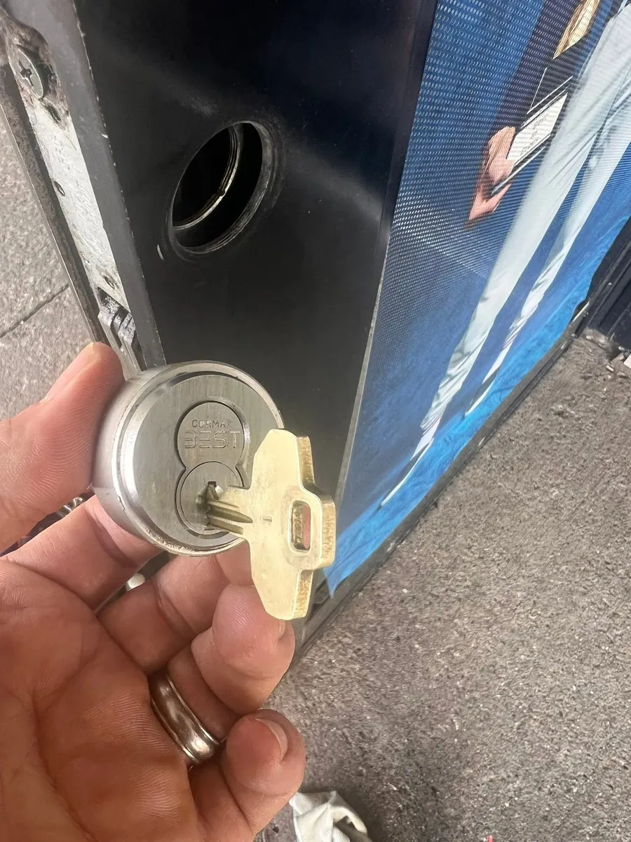 Lock cylinder and key removed from a commercial door