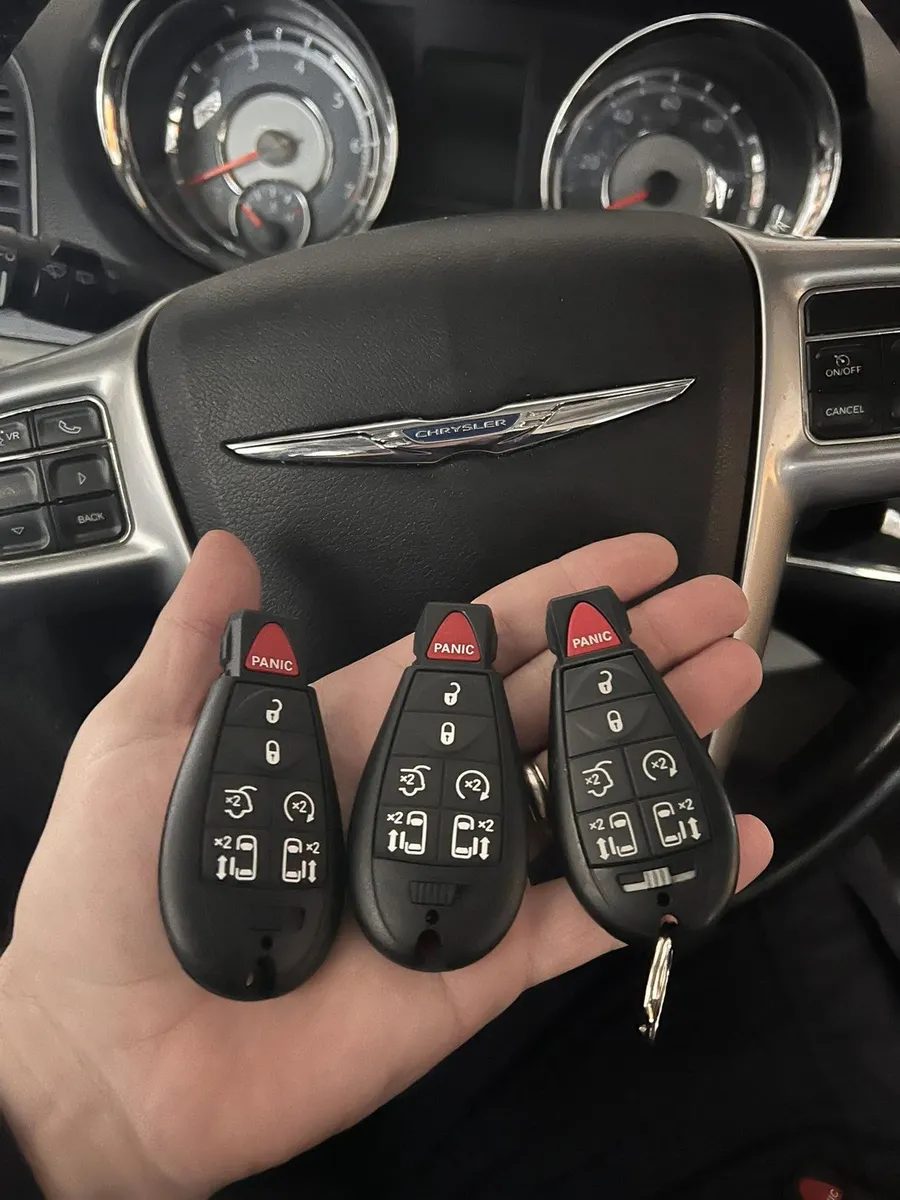 Three Chrysler remote keys at the steering wheel
