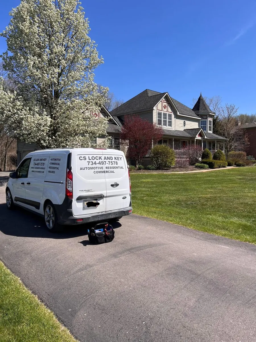 CS Lock and Key van parked at a home in spring