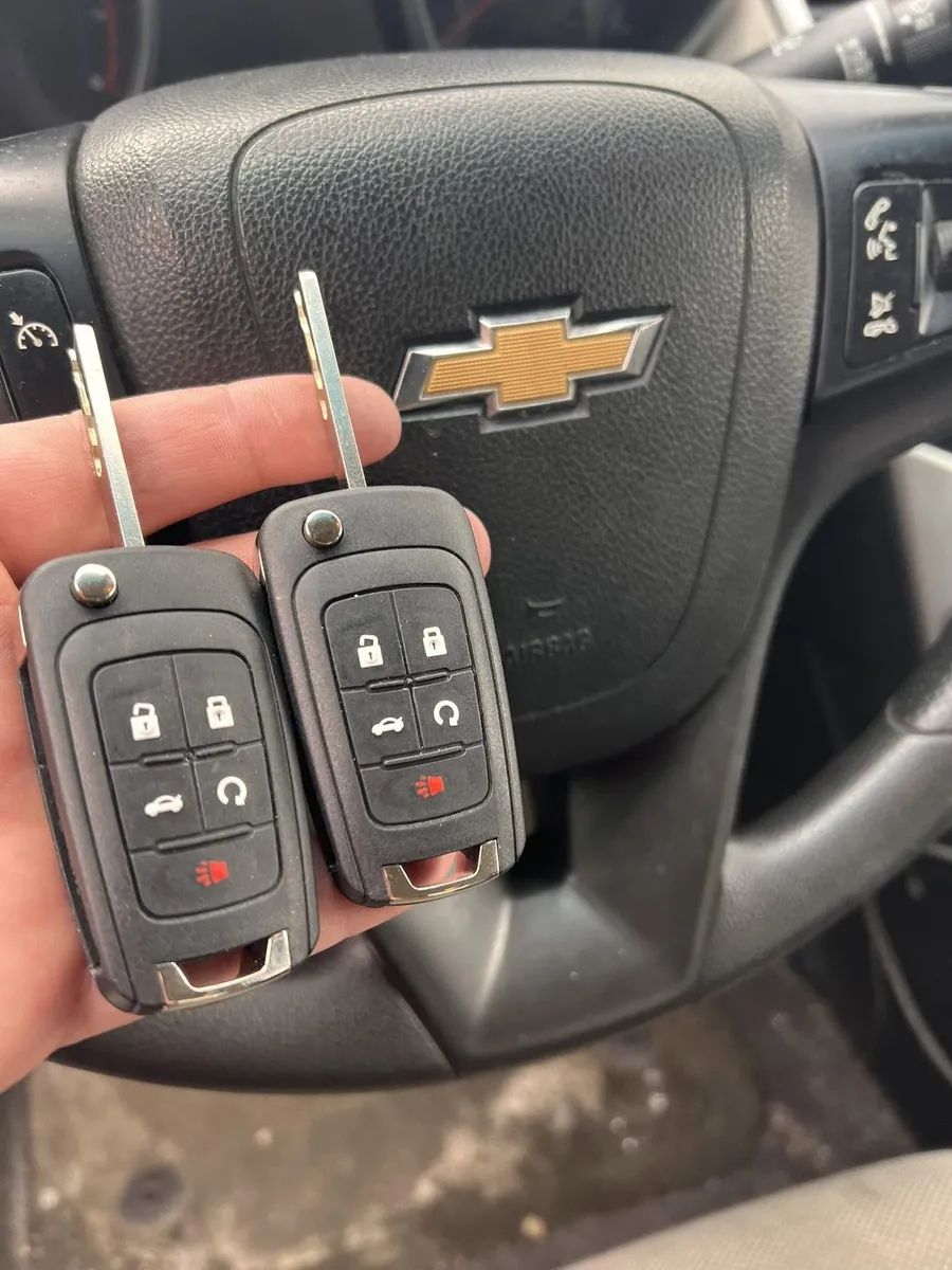 Two Chevrolet flip keys at the steering wheel