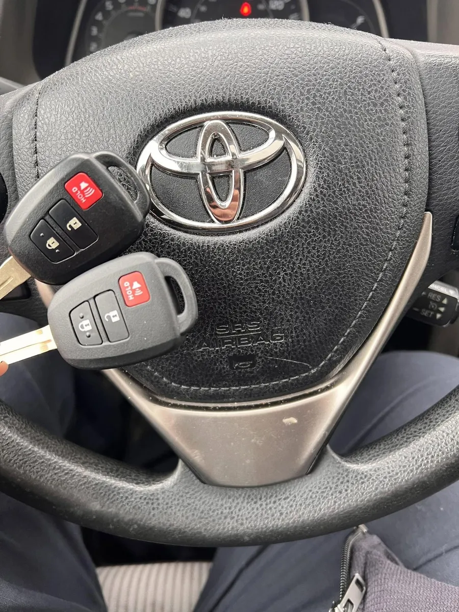 Two Toyota remote head keys at the steering wheel