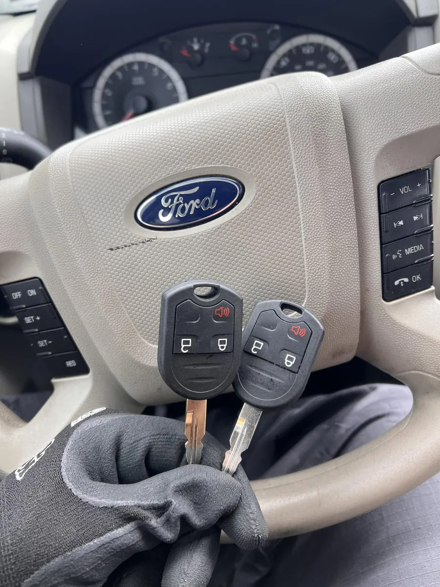 Two Ford remote head keys at the steering wheel