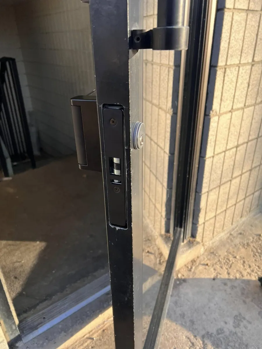 Deadlatch and cylinder on an aluminum storefront door
