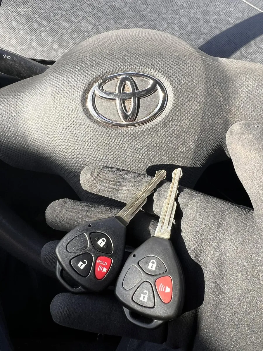 Two Toyota remote head keys at the steering wheel