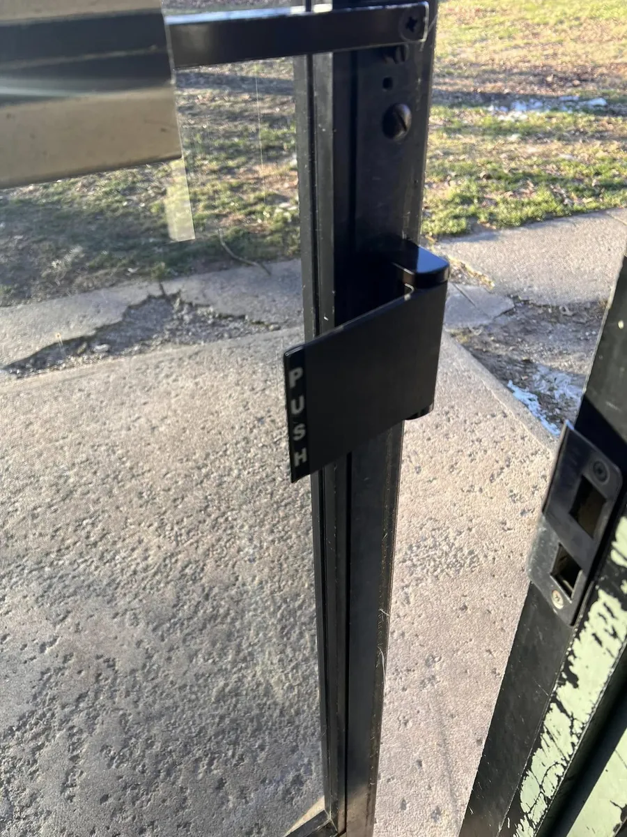 Push paddle handle on a storefront door