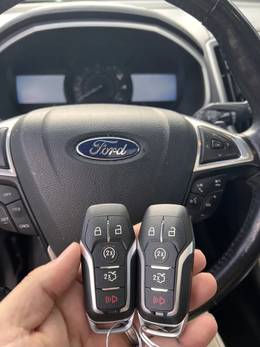 Two Ford smart keys at the steering wheel