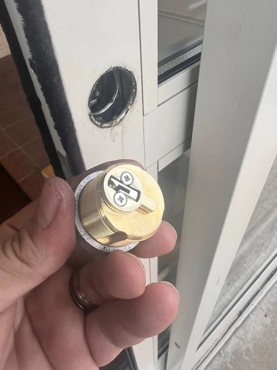 Brass mortise cylinder removed from a storefront door