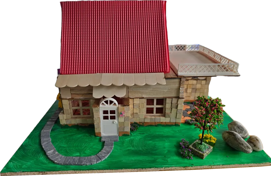 A handmade house with a red roof, terrace and garden