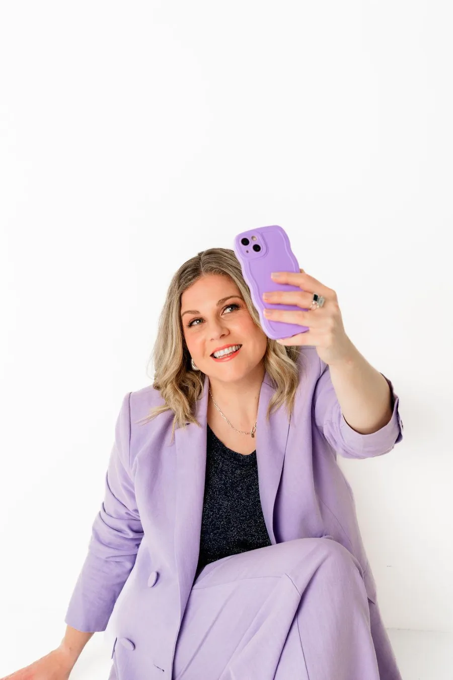 Zoë Condon working with a laptop and phone, building digital strategy