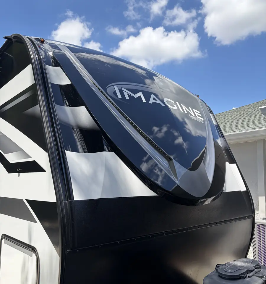 Glossy front cap of a travel trailer after exterior polish and protection by King Luxury Detailing