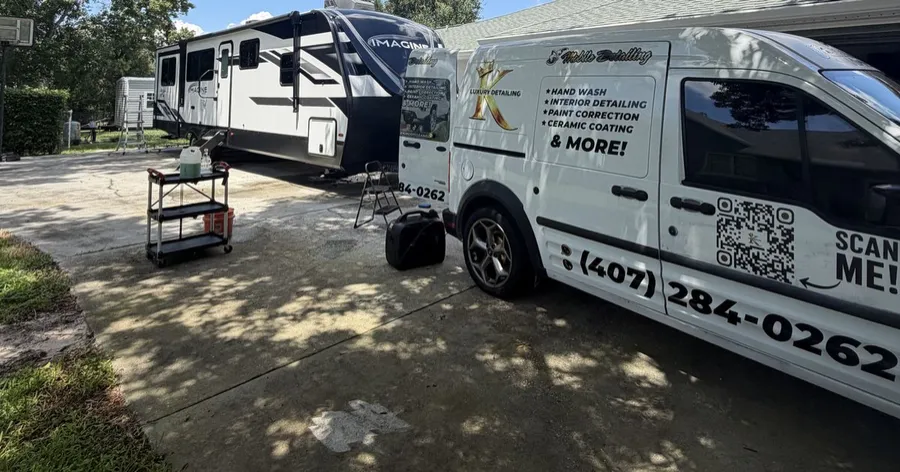 King Luxury Detailing mobile van next to a freshly detailed travel trailer in the Orlando area
