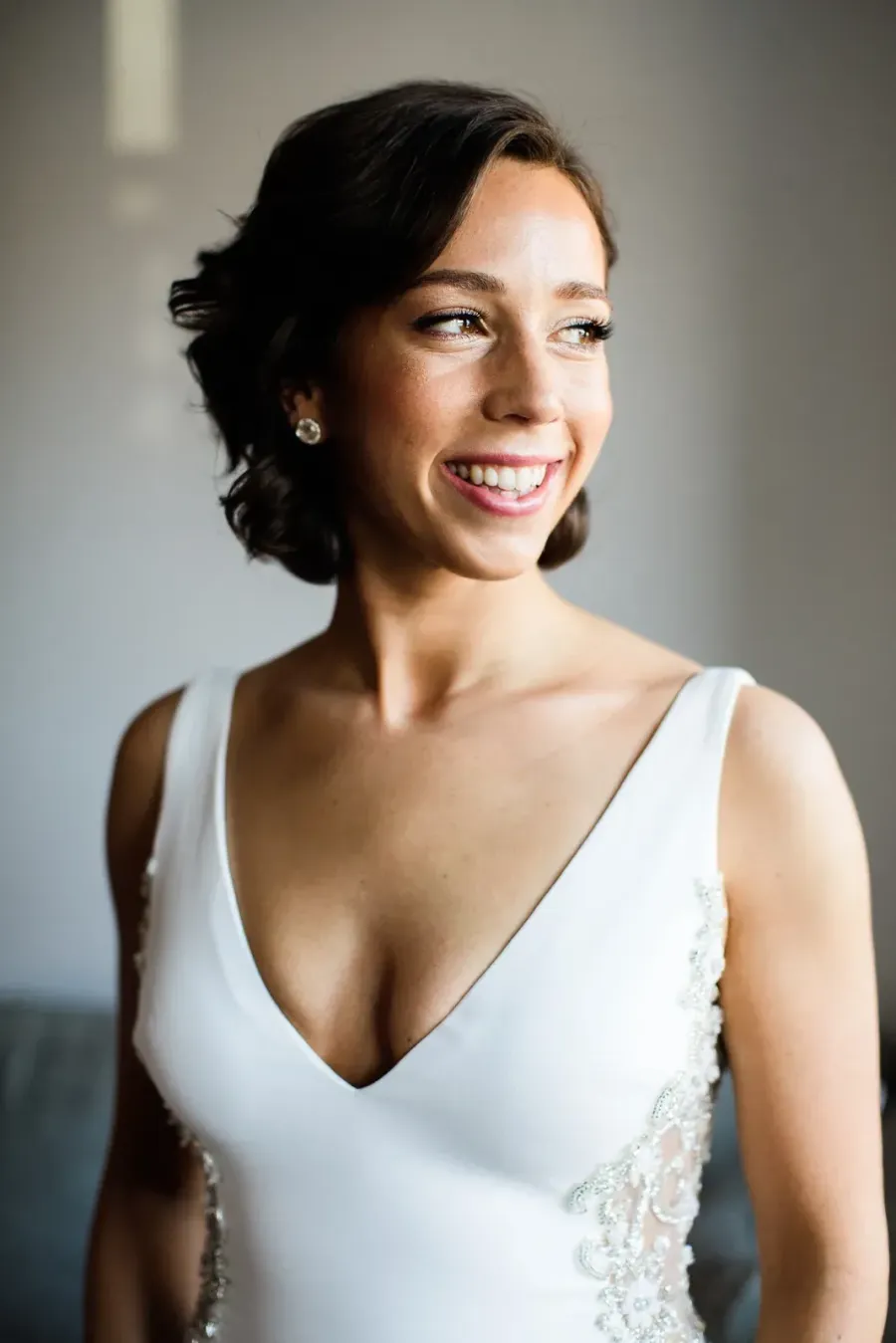 Guest with natural airbrush makeup and a low, polished hairstyle