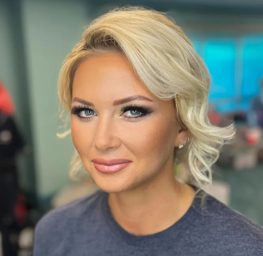 Event guest with airbrush makeup and a bold red lip