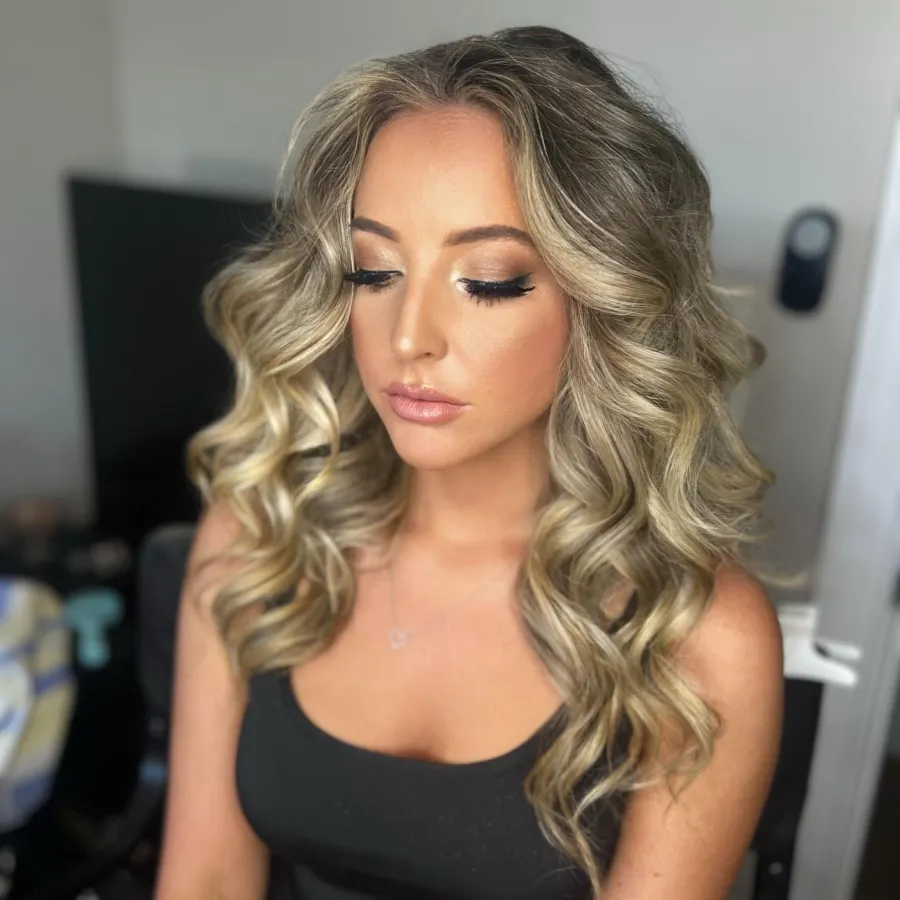 Guest with gala makeup and long, brushed-out waves