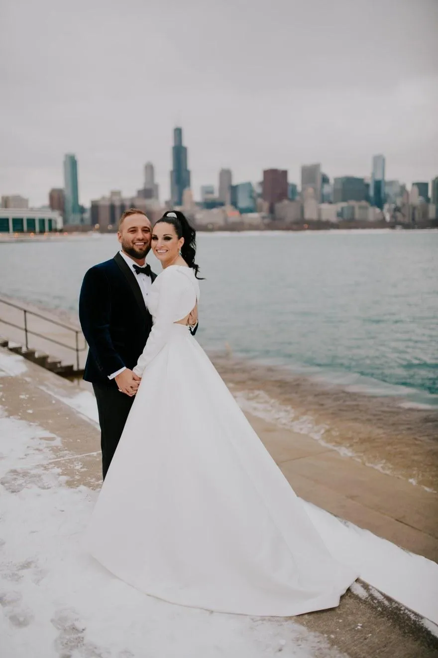 Winter wedding couple on the Chicago lakefront with the skyline behind them