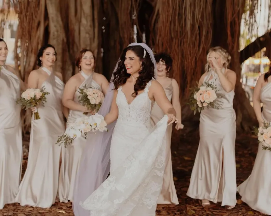Bride laughing with her bridesmaids under a banyan tree, Tampa Bay wedding
