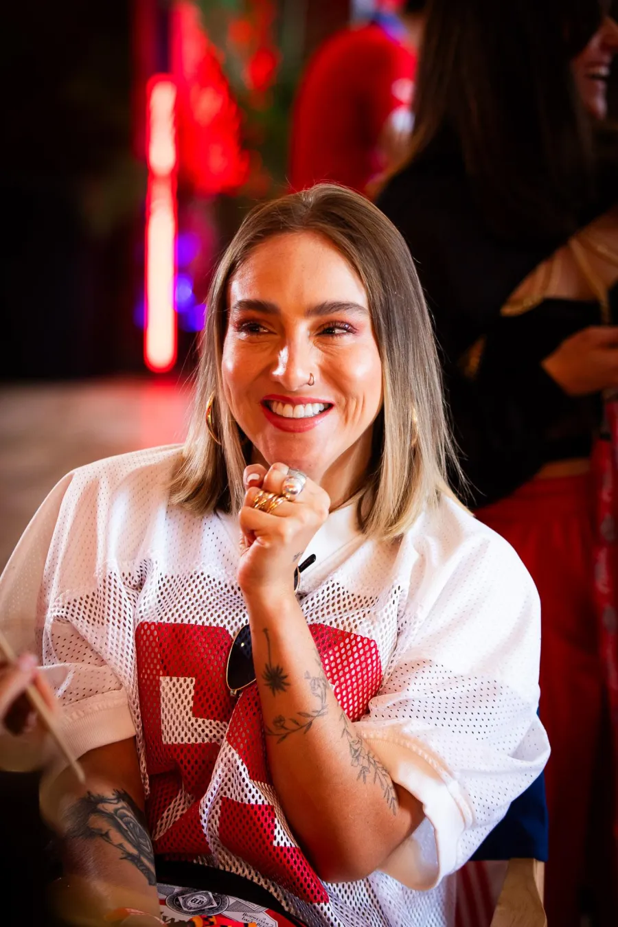 Smiling guest in a Budweiser jersey after her glam
