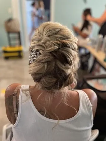 Braided and pinned updo styled for a black tie evening