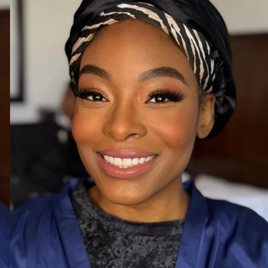 Smiling bride in a headwrap with airbrush makeup on deep skin