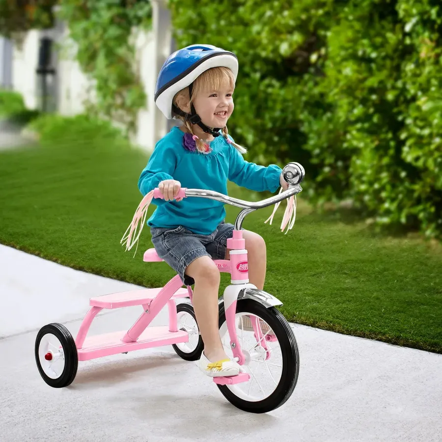 Girl riding a pink Radio Flyer bike outdoors for a Radio Flyer campaign