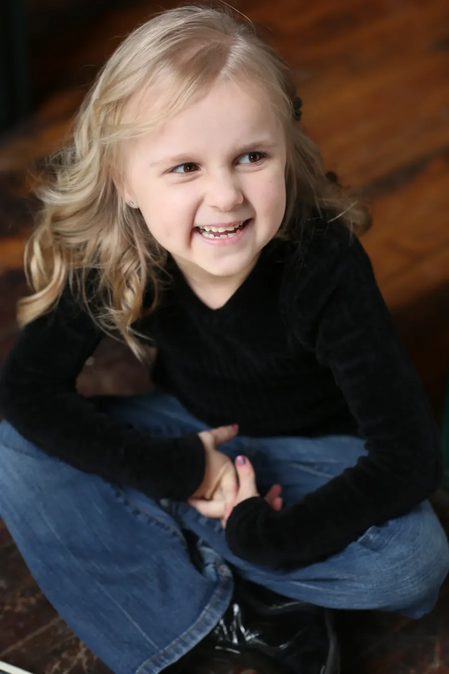 Young girl seated for a child model portfolio portrait