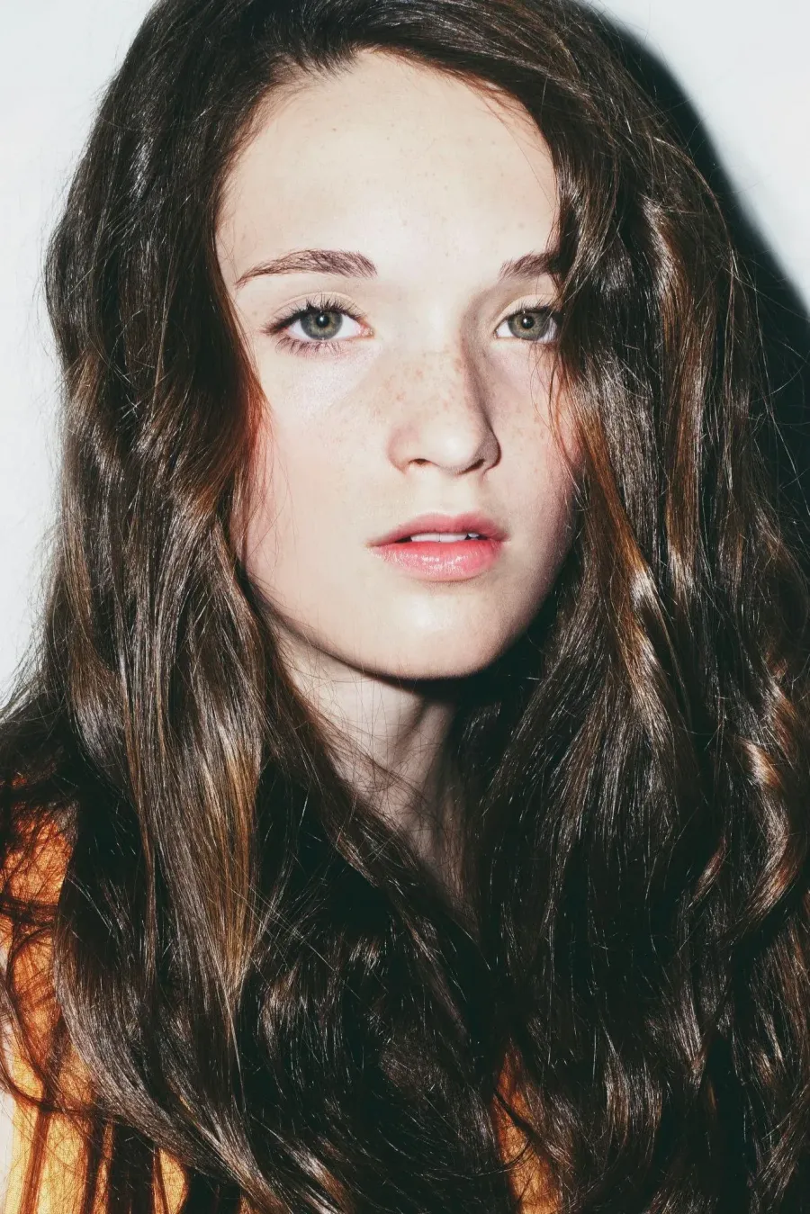 Beauty close-up showing natural freckles through a light, even base