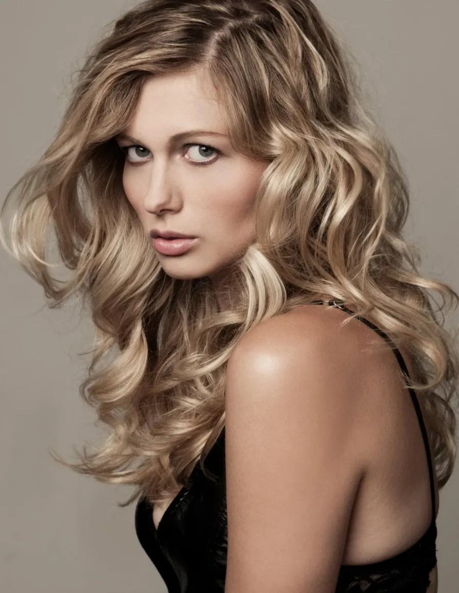 Beauty portrait with glowing skin and voluminous blonde curls