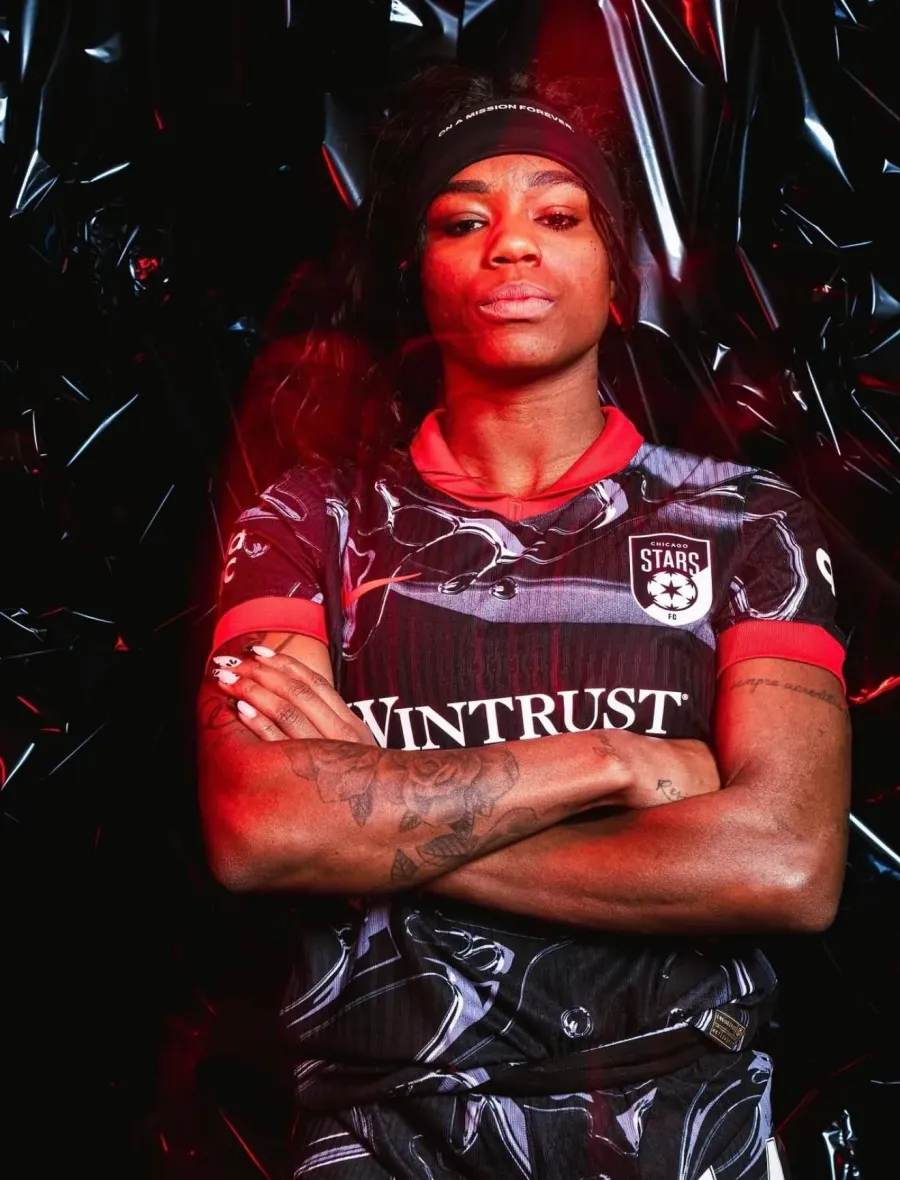 Chicago Stars FC media day portrait, arms crossed under dramatic lighting