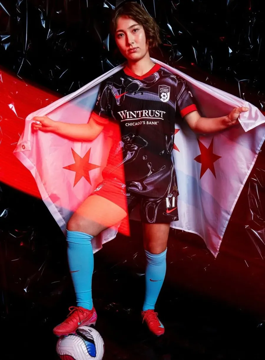 Chicago Stars FC player holding the Chicago flag at NWSL media day
