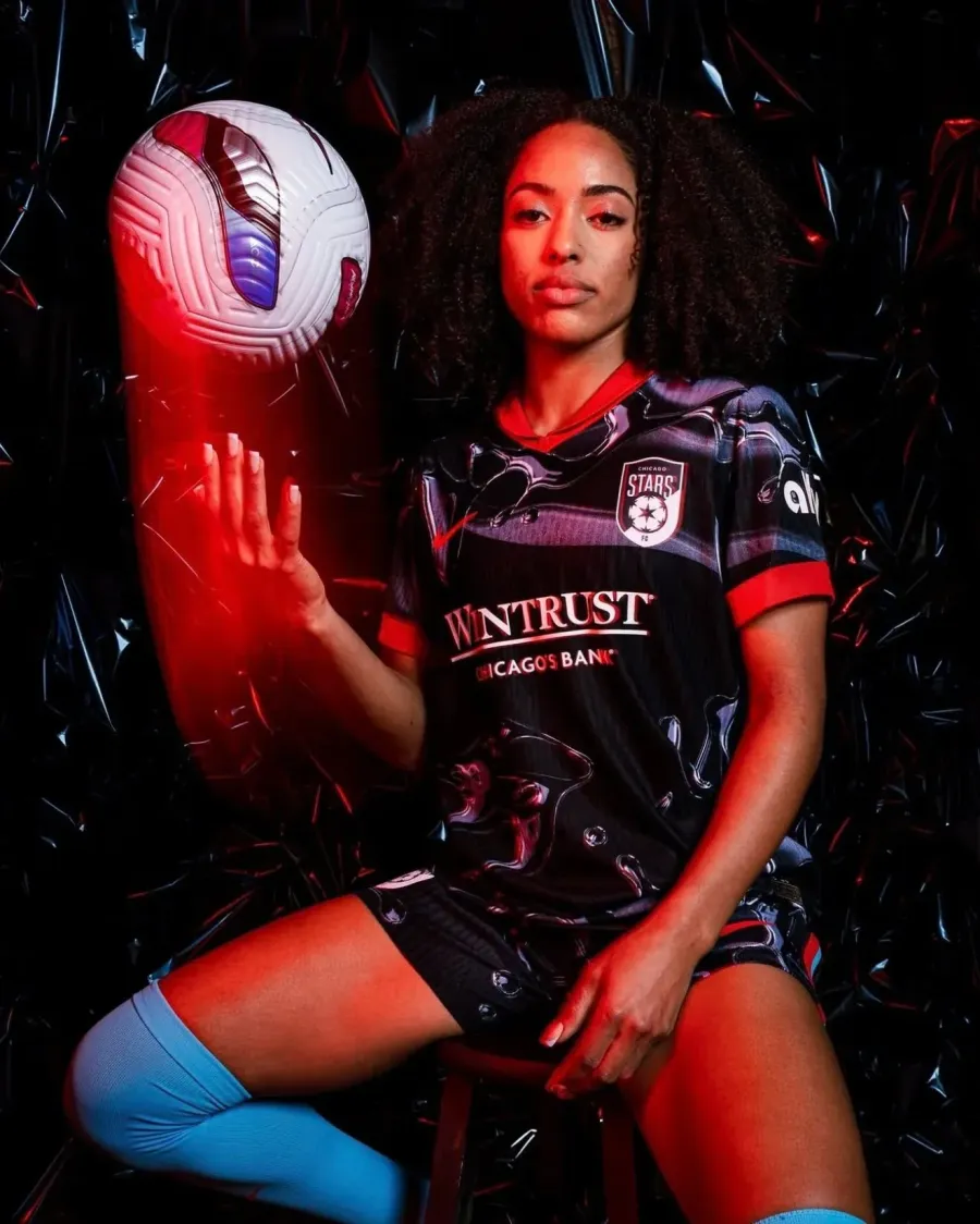 NWSL media day portrait of a Chicago Stars FC player kneeling with the ball
