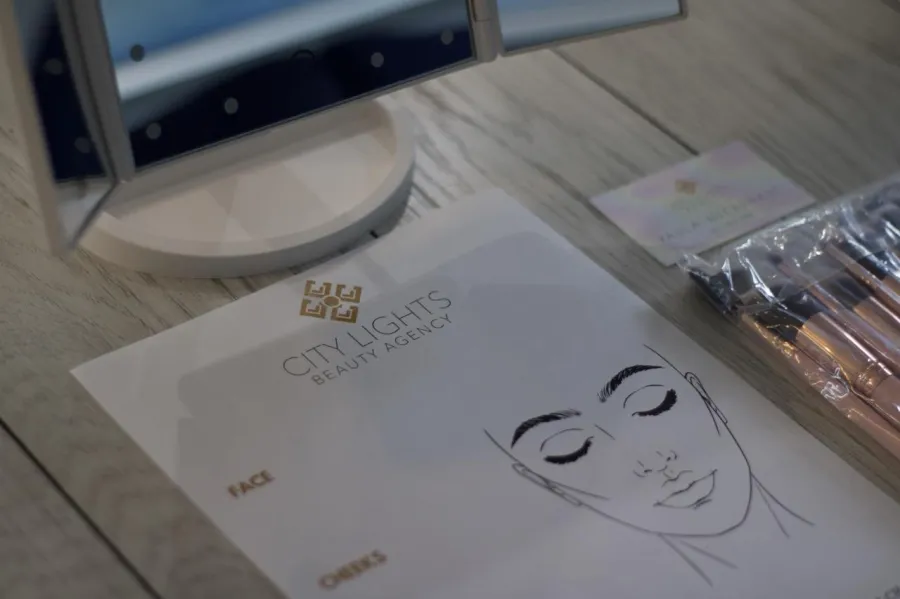 City Lights face chart and a brush set laid out at a lesson place setting