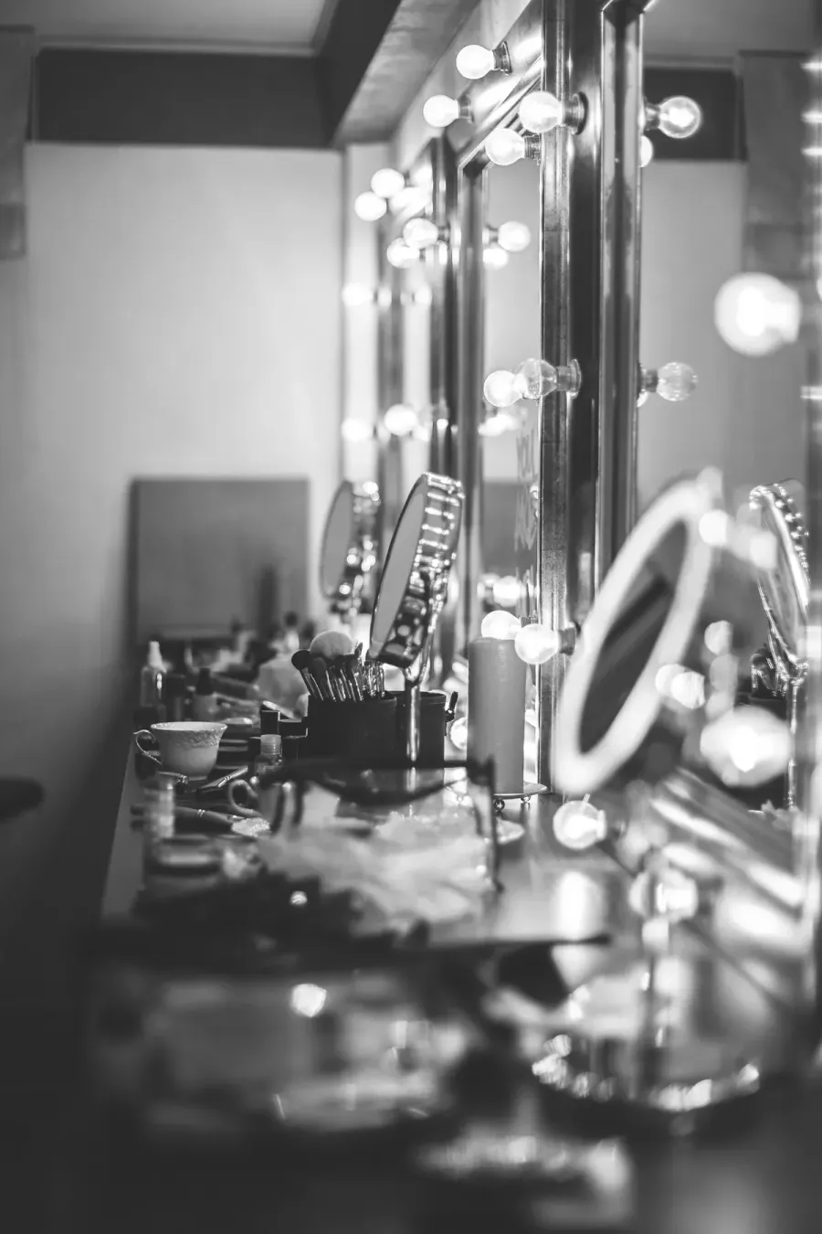 Black and white glam bar with lit vanity mirrors set up on location