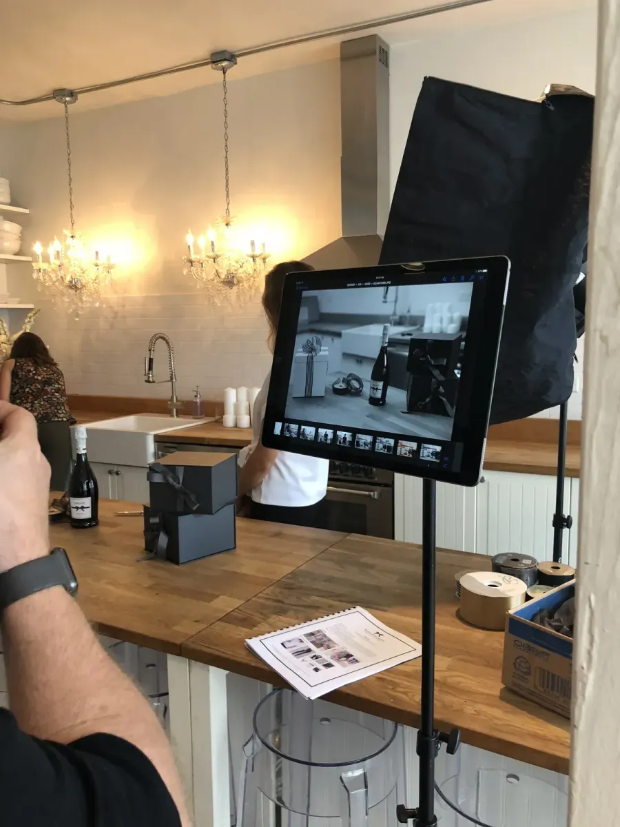 Virtual makeup lesson setup: monitor, lighting and a kit laid out on the desk
