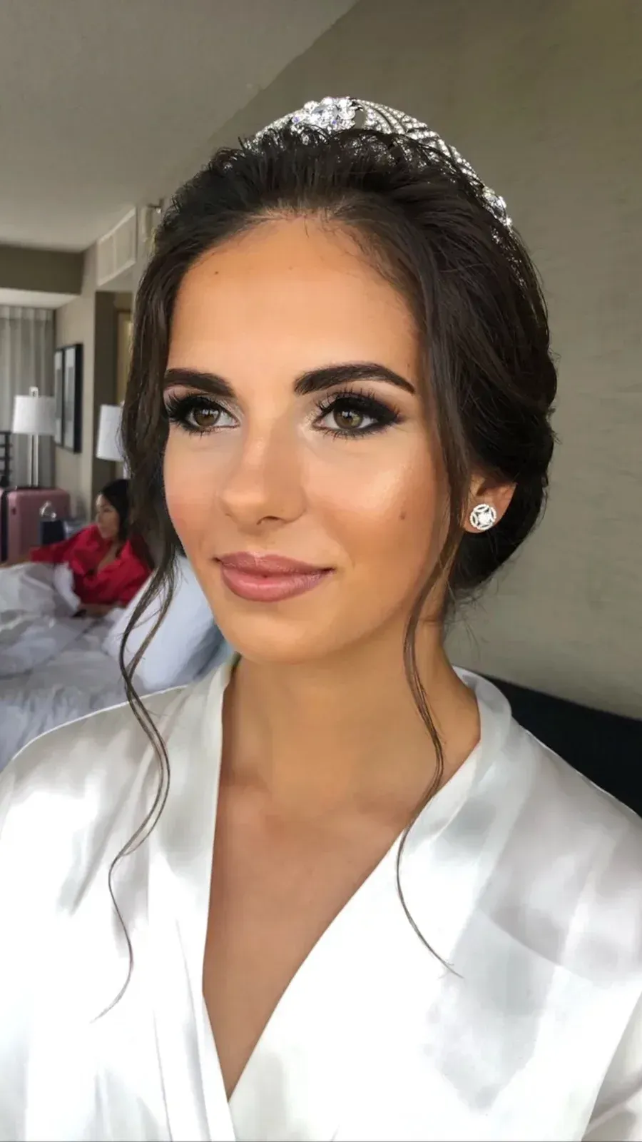 Bride in a tiara with soft-glam airbrush makeup in the bridal suite