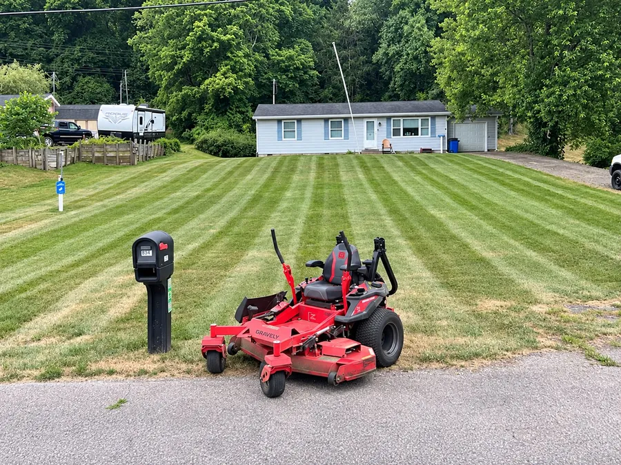 A freshly mowed lawn with clean cut stripes running across it