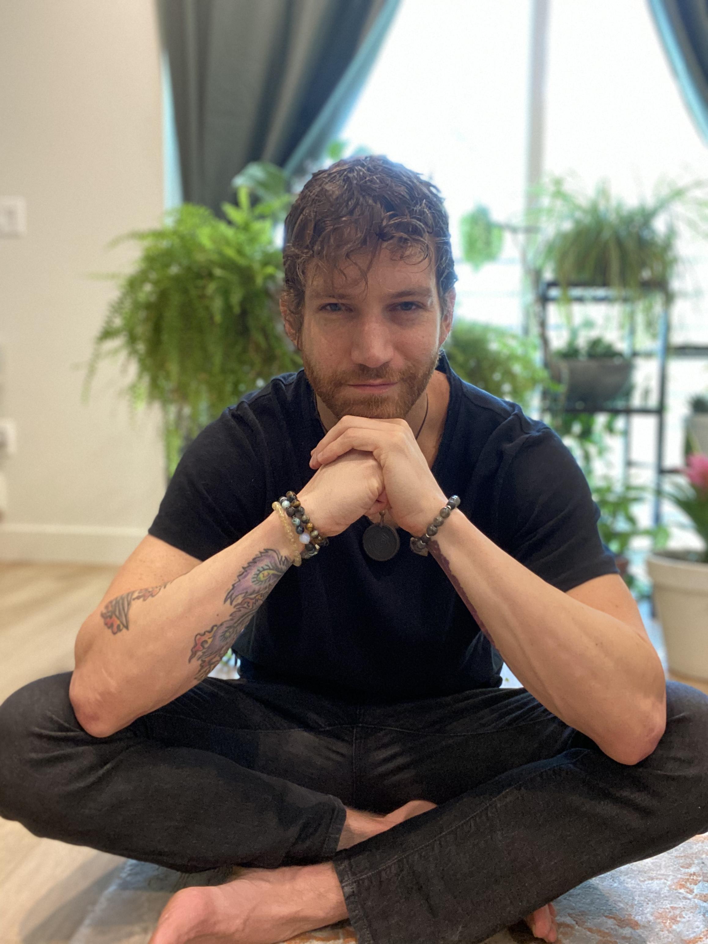 Daniel sitting cross-legged