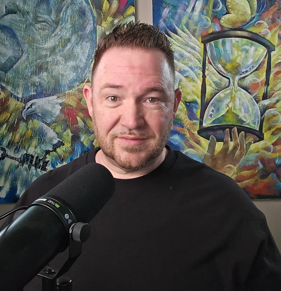 Adam Hagaman at a podcast microphone