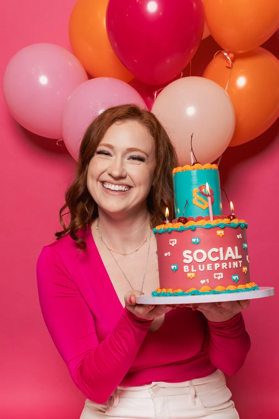 Nikki holding a Social Blueprint cake
