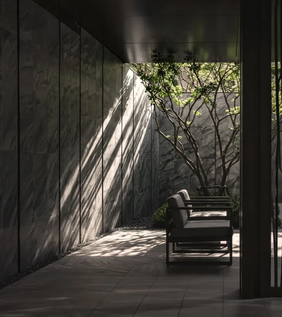 Stone, shade and a single tree at the arrival, Aetas Taman Desa, artist's impression