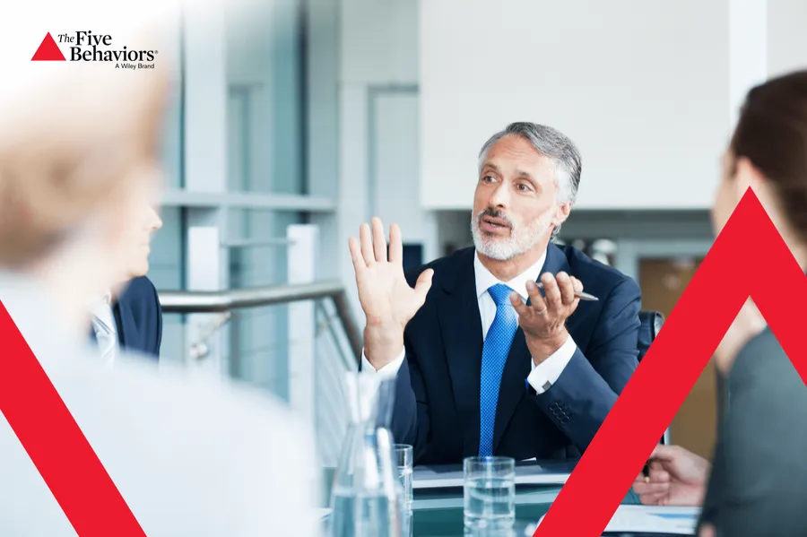 A facilitator in discussion with a group. Photo: The Five Behaviors®