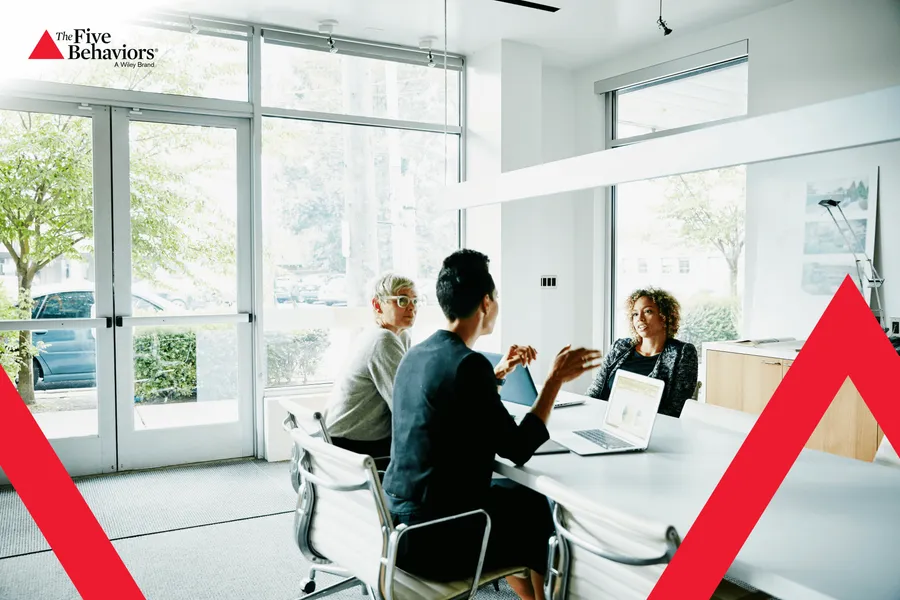 A team in a meeting. Photo: The Five Behaviors®