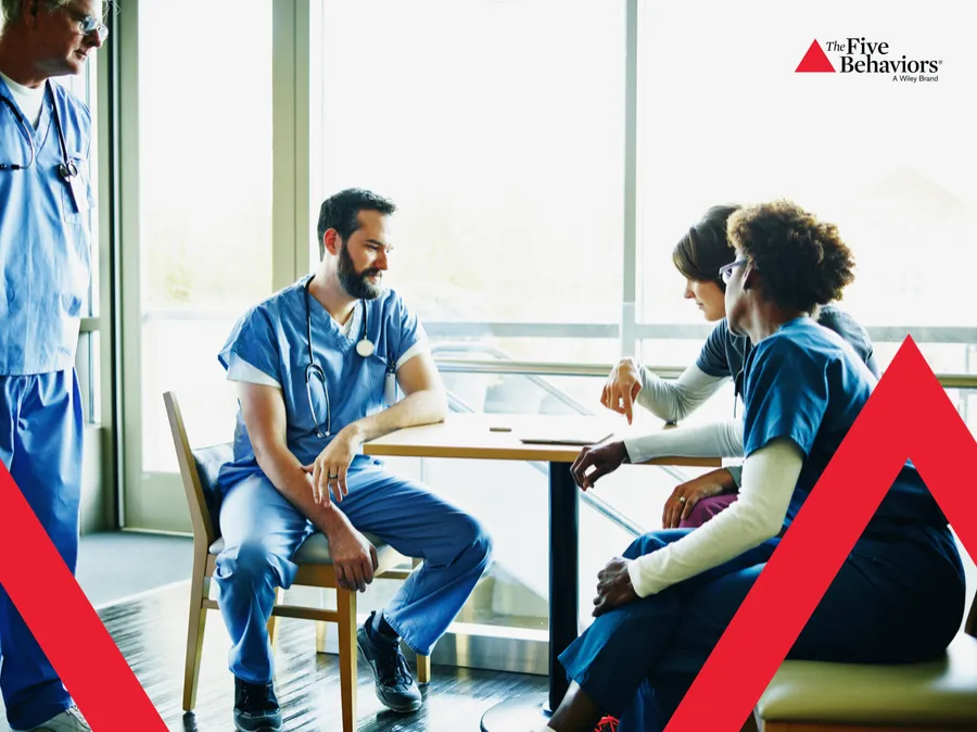 Colleagues talking together. Photo: The Five Behaviors®